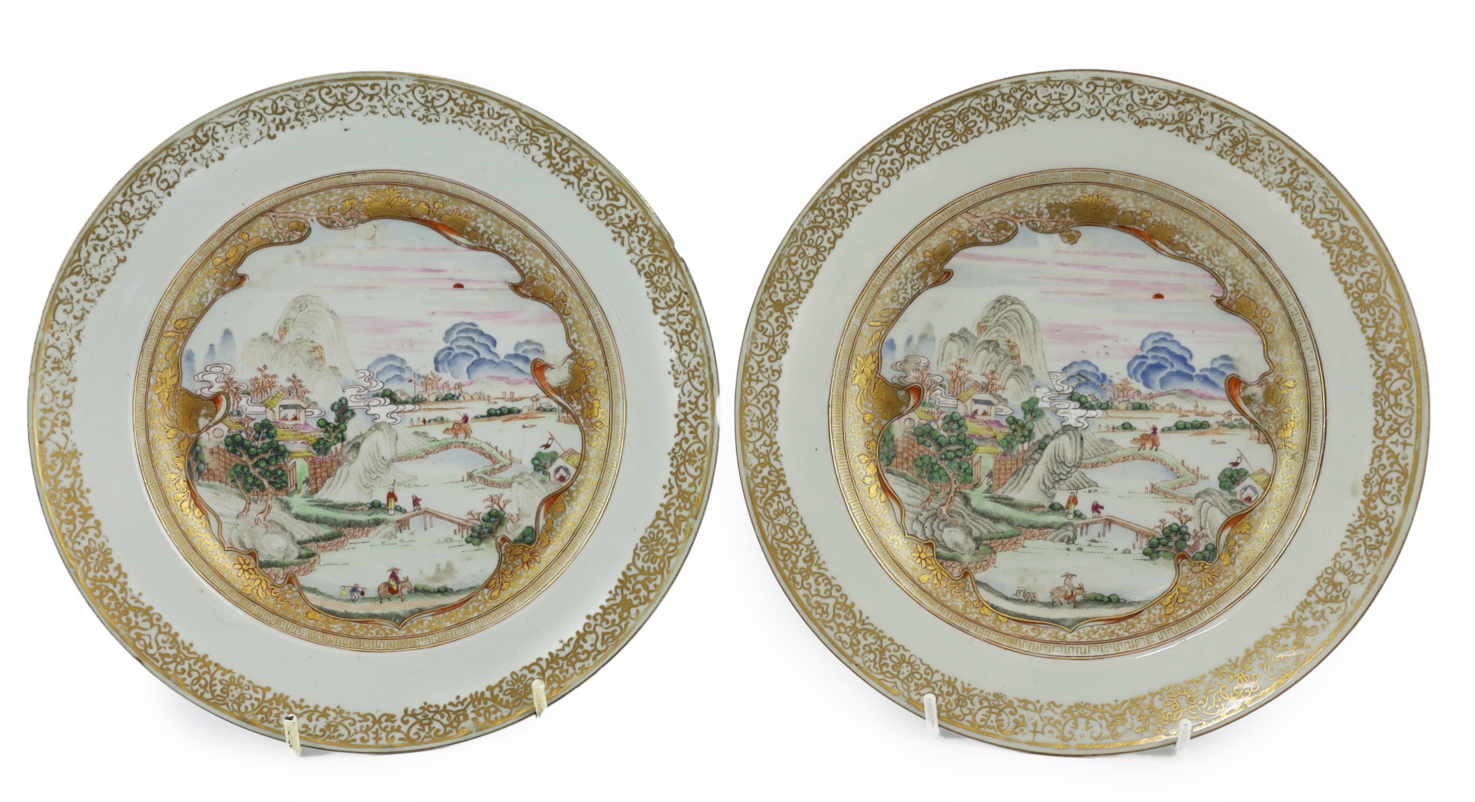 A pair of Chinese famille rose ‘landscape’ plates, Yongzheng-Qianlong period, small edge chip